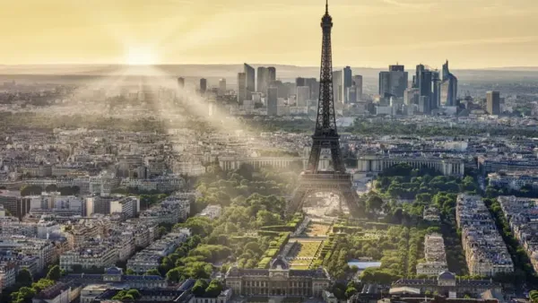 Vue aérienne de Paris avec la Tour Eiffel au premier plan et le quartier de La Défense en arrière-plan, symbolisant l'investissement immobilier diversifié.