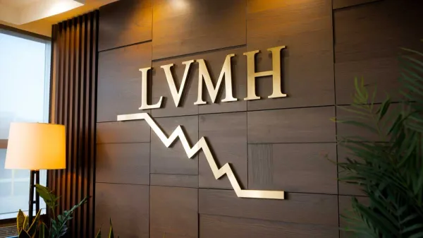 Logo LVMH avec un graphique boursier descendant, symbolisant une année difficile pour le luxe français.